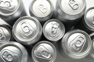 Many different tin cans on light background, top view