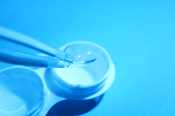 Taking contact lens from case on light background, closeup. Space for text