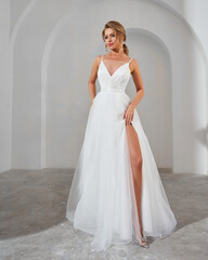 Elegant woman in white dress with slit