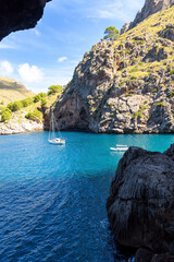 Sailboats floating in the crystal waters of Torrent de Pareis in Mallorca