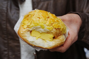 A delicious crispy pineapple bun (菠蘿包, bo lo bao) fresh from a Hong Kong bakery, served warm...