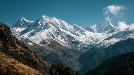 Vast snow-capped mountain range under a clear sky.
