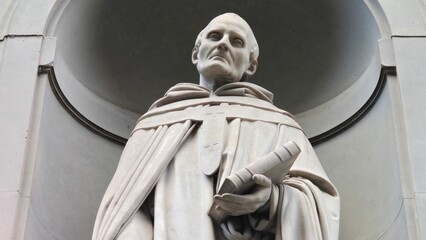 Florence, Italy - 3 January 2025. Close-up of the marble statue of Saint Antoninus by Luigi Pazzi, showing the Dominican friar holding a book, located in a niche at the Piazzale degli Uffizi.
