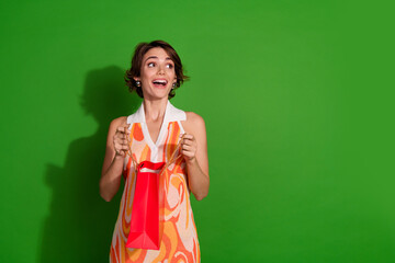 Photo of attractive young woman shopping bags look shocked empty space dressed stylish colorful...