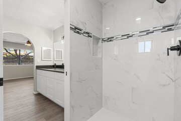 A modern bathroom featuring a spacious walkin shower along with a sink
