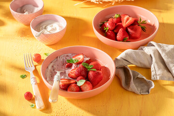 Tasty and creamy strawberries with sugar and yogurt.