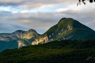 Mountain Landscapes with Forested Hills and Atmospheric Skies
