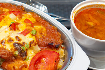 angle view tomato pork chop rice with borscht