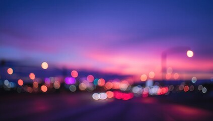Blurry city lights at sunset create a vibrant urban scene.