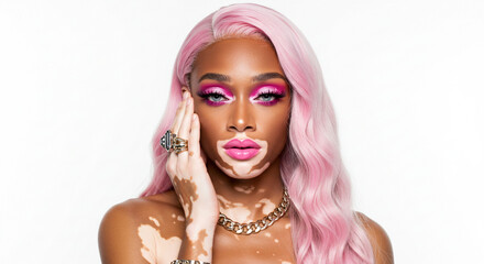 Lgbtqiapn+ pride month portrait of a woman with vitiligo wearing pink makeup and a pink wig against a white background