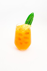 orange citrus cocktail with tropical leaf garnish served in transparent glass over ice on clean white background. High quality photo