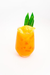 orange citrus cocktail with tropical leaf garnish served in transparent glass over ice on clean white background. High quality photo