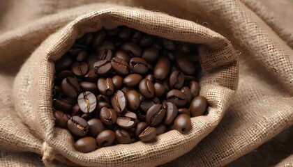 Close-up of roasted coffee beans in a rustic burlap sack, blurred background.