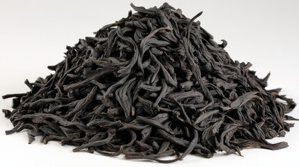 Close Up of Dark Brown Dried Black Tea Leaves Piled on White Background