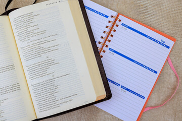 24 April 2025 Washington DC US Holy Bible with literary text alongside planner featuring weekly layout for organizing upcoming events.