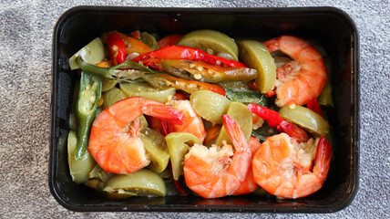 Tumis Udang or Stir tomato Prawns with chili and oyster sauce as Asian food. Served on white blox. Selective focus