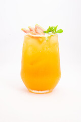 orange peach cocktail with strawberry slices and fresh mint served in transparent glass over ice on white background. High quality photo