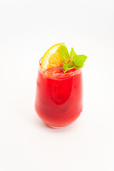 vibrant red berry cocktail with orange slice and fresh mint leaves served in clear glass with ice on white background. High quality photo