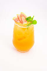 orange peach cocktail with strawberry slices and fresh mint served in transparent glass over ice on white background. High quality photo