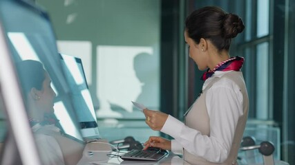 receptionist at desk in airport : Hispanic woman receptionist helping traveler with passport for check in at terminal counter