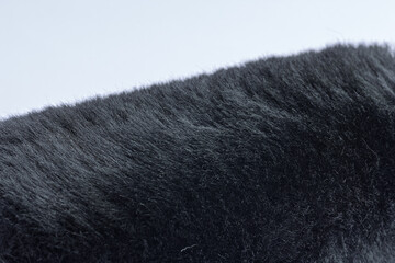 close up of black fluffy faux wool fur car wheel spoke brush