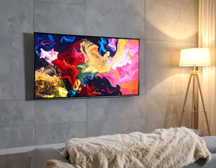Modern living room featuring an abstract art display on a sleek TV screen. The scene is complemented by a cozy sofa and warm lighting. Ideal for home decor, tech, or design concepts.
