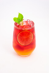 vibrant red citrus cocktail with blood orange slice and fresh mint served in clear glass over ice...