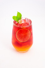 vibrant red citrus cocktail with blood orange slice and fresh mint served in clear glass over ice...