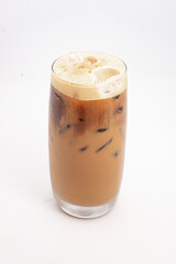 iced coffee with cream and ice cubes served in tall clear glass with foamy top photographed on white background. High quality photo