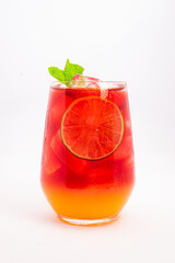 vibrant red citrus cocktail with blood orange slice and fresh mint served in clear glass over ice on white background. High quality photo
