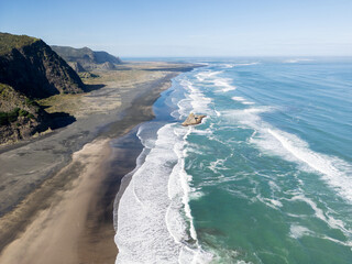 Aerial Coastal Landscape of Karekare Beach with Ocean Waves in New Zealand