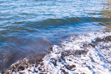 Rough seas and crashing waves in motion blur creating a dynamic texture of stormy surface of the ocean, ocean water background.