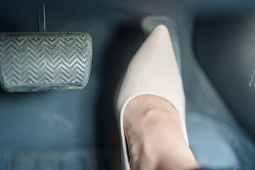 Female driver in high heels, business woman driving car and pushing car break and accelerator...