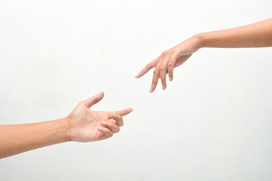 male and female hands reaching towards each other on isolated white background