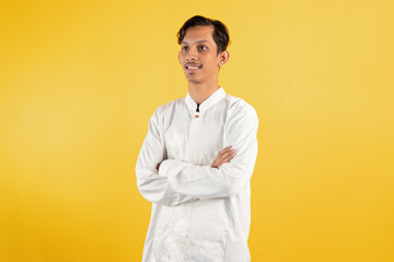 Smiling muslim man wear white shirts with Islamic ornaments while folded arms