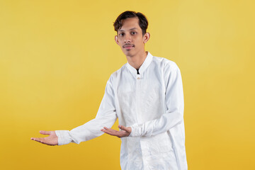 Muslim man wear white shirts with Islamic ornaments welcoming or showing