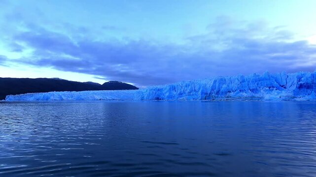 POV early morning at sea level of the PIO XI Glacier in Chile Torres del Paine showing a very blue hue on the glacier and the sea