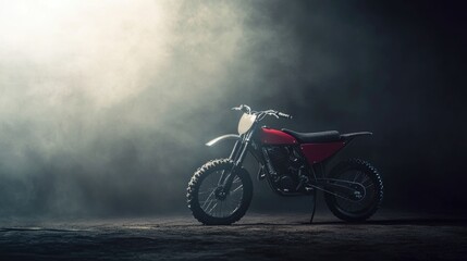 Obraz premium Red Motocross Bike in Dramatic Smoky Setting