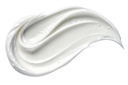A close up of a swirl of white cream or lotion against a dark black background in a studio shot