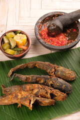 Pecel Lele, sambal, sayur Asem. fried catfish chili sauce, sour vegetables. Indonesian food.
