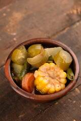 Sayur asem. Sayur asam is a type of sour vegetable dish typical of Indonesia. served on an earthenware bowl