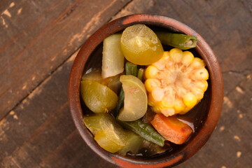 Sayur asem. Sayur asam is a type of sour vegetable dish typical of Indonesia. served on an earthenware bowl
