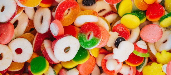 Assorted multi-colored marmalade candies. Jelly candy background. View from above. panoramic