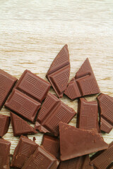 Top View of chocolate chunks scattered on wooden background