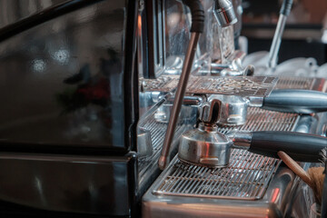 The automatic coffee maker is currently brewing a delicious espresso, with the rich, aromatic, brown-hued coffee streaming down into the pristine white coffee cup.