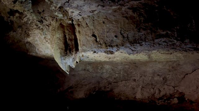 Journey into a fascinating cave system where guide explains the unique geological features. Observe breathtaking rock formations and colorful lighting enhancing the natural beauty