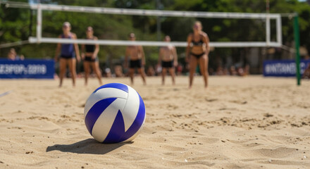 Blue and white volleyball on sand, players in swimsuits near net, trees in background. Sport, teamwork, outdoor activity, fitness, summer events, tournament sale. Horizontal banner