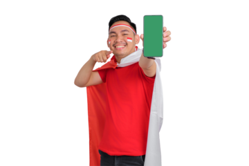 Cheerful young Asian man showing a blank screen mobile phone isolated on transparent background. Indonesian independence day concept