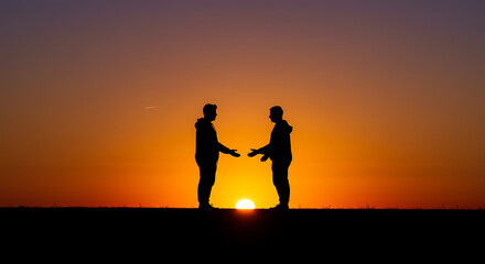Golden sunset silhouettes two friends reaching out a breathtaking bond of friendship