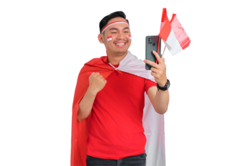Excited young Asian man celebrating with a mobile phone isolated on transparent background. Indonesian independence day concept